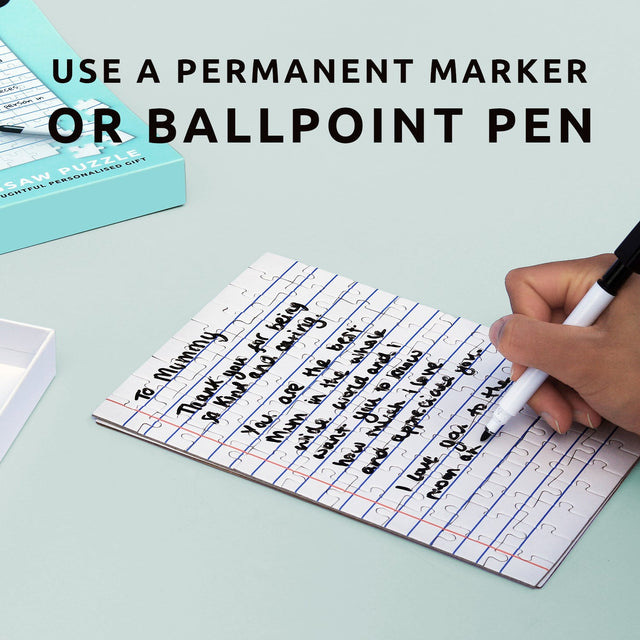 Child's hand writing a personalised hand written letter with a blue ballpen on Pikkii's Blank Letter Jigsaw with black permanent marker