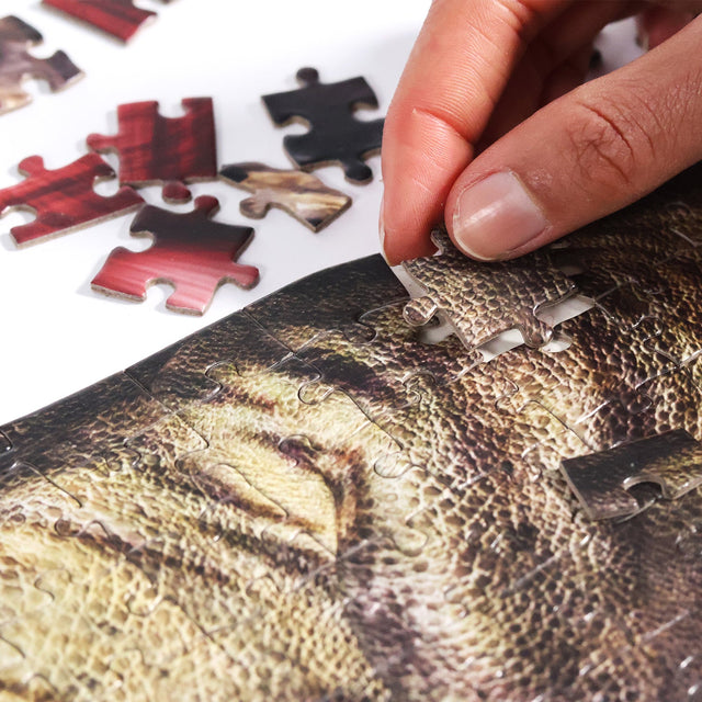T-Rex Layer Jigsaw Puzzle by Pikkii - Close Up of Hand Putting Together Layer