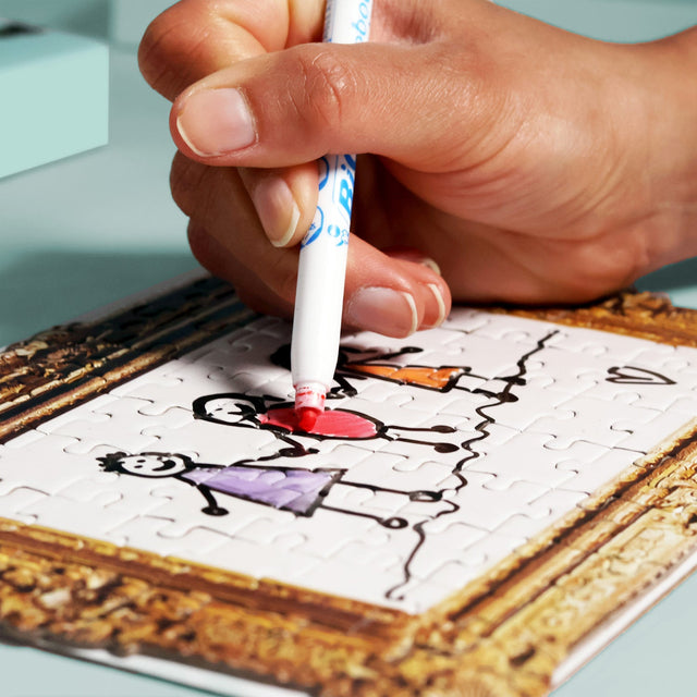 Close up of hand drawing on Pikkii framed drawing blank jigsaw puzzle with a drawing of a family